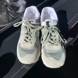 New Balance 574. They are a green color and a size 9.5 in woman’s.